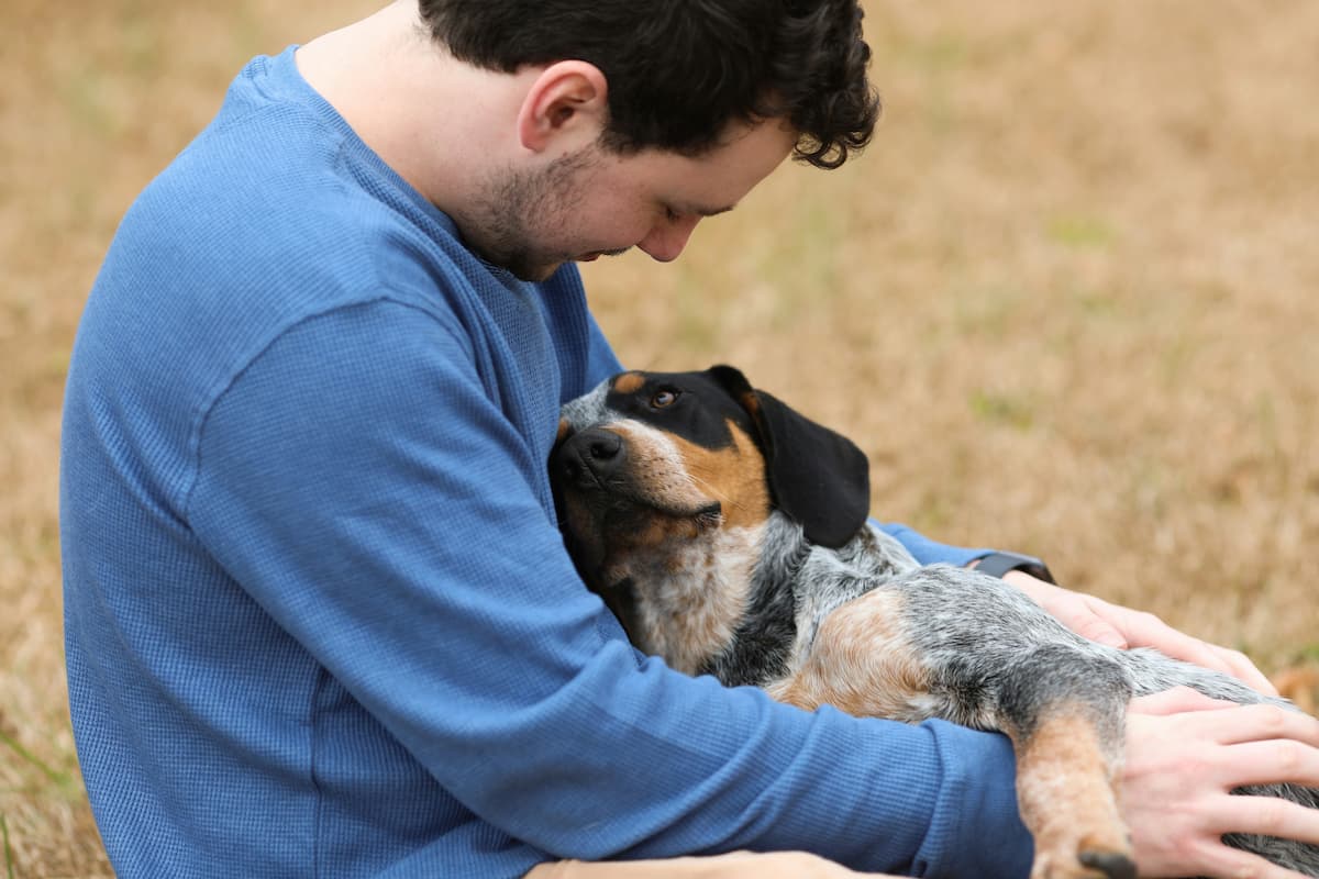 Dog cuddling with owner